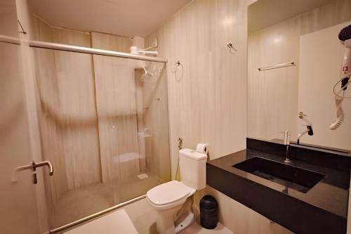 a bathroom with a shower and a toilet and a sink at Hotel Amazon Seasons VN in Belém