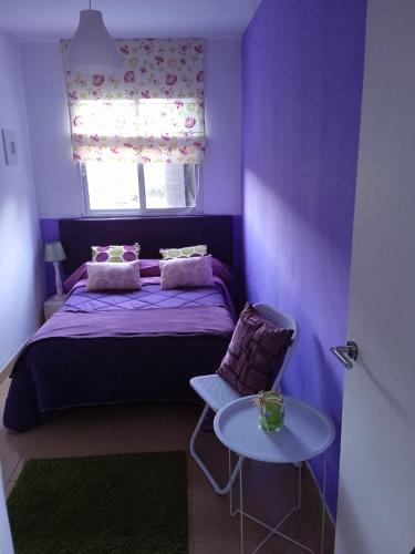 a purple bedroom with a bed and a table at lugar del pazo nª9-albeos in Albeos