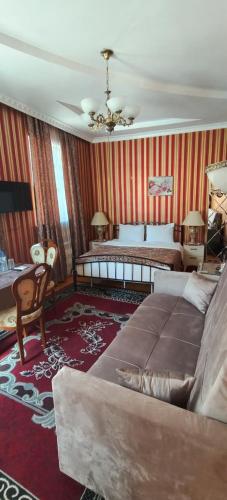 a bedroom with a bed and a couch in it at Retro Silent Boutique Hotel in Baku