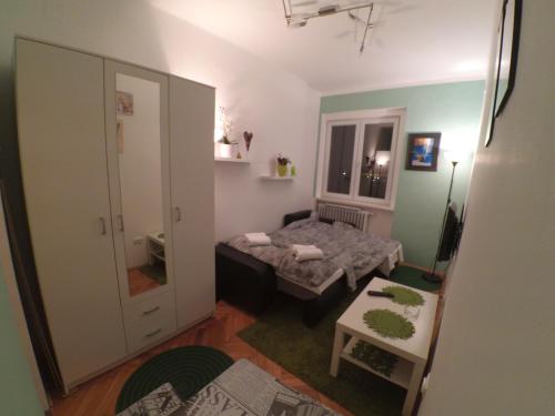 a small room with a bed and a table at Sleep and Go Pedja in Belgrade