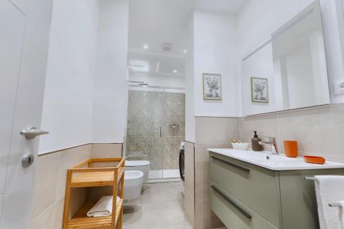 a bathroom with a sink and a toilet and a shower at My Tuscany Green Apartment in San Quirico dʼOrcia