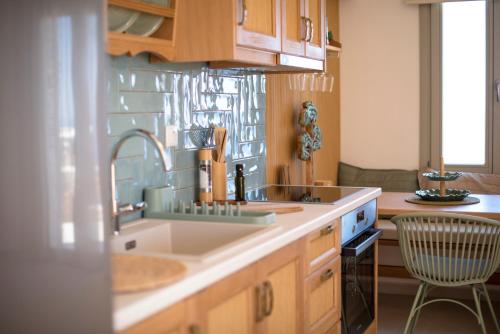 a kitchen with a sink and a counter top at Vounara Houses in Artemonas