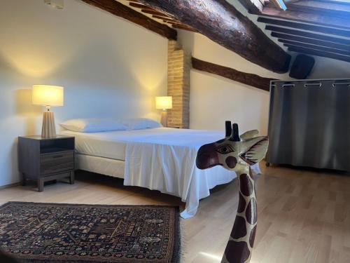 a bedroom with a giraffe statue in the middle of a bed at Mas San Salvador in Bompas