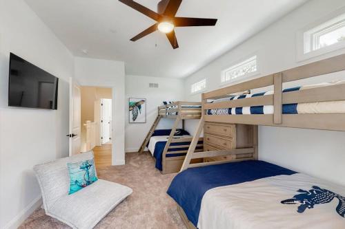 a bedroom with two bunk beds and a ceiling fan at Sapphire Sol in Ocean City