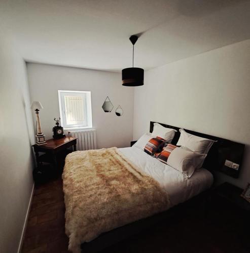 a bedroom with a large bed and a window at Bastide de la Couloubre in Mallemort