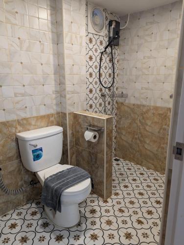 a bathroom with a toilet and a shower at Pion Hotel Ayutthaya in Phra Nakhon Si Ayutthaya