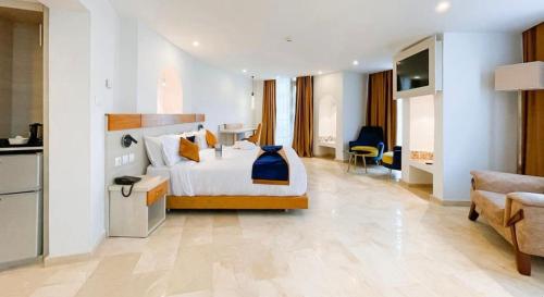 a hotel room with a bed and a living room at Centre Touristique Le Sable in Alger