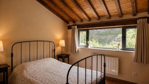 a bedroom with a bed and a window at Las Hayucas in San Roque de Ríomiera
