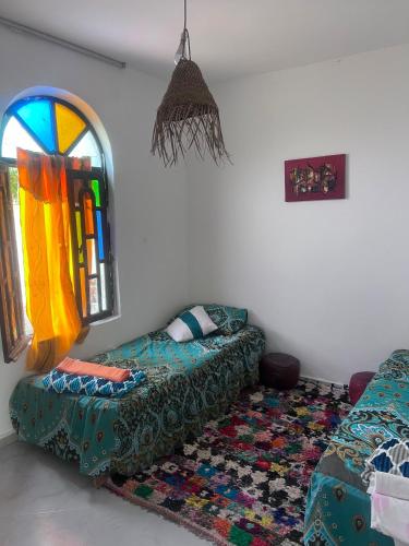 a living room with a couch and a window at Villa compagne sans vis-à-vis in Ounara