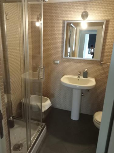 a bathroom with a sink and a toilet and a mirror at Bastioni VALE in Pescara