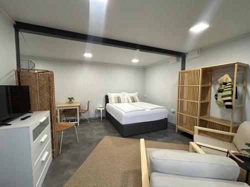 a bedroom with a bed and a tv in a room at MühlengasseONE in Lenzing