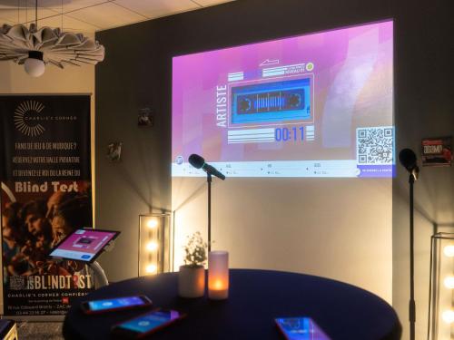 a stage with a large screen with a microphone at ibis Compiegne in Compiègne
