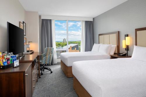 a hotel room with two beds and a television at Hampton Inn by Hilton Halifax Downtown in Halifax