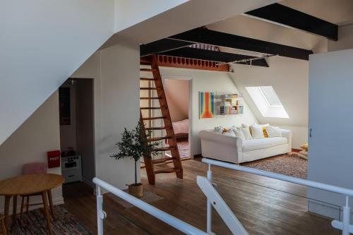 a living room with a staircase and a couch at Villa Circus in Halmstad
