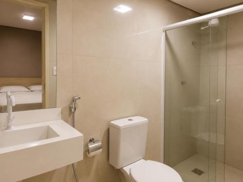 a bathroom with a toilet and a sink and a shower at Smart Hotel Aeroporto by Bsb Inn in Brasília