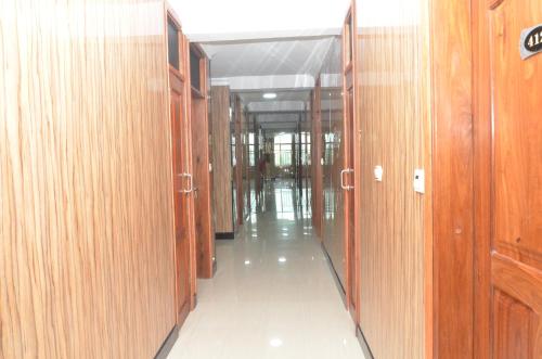 a hallway with wooden doors at Nefaland Hotel in Dar es Salaam