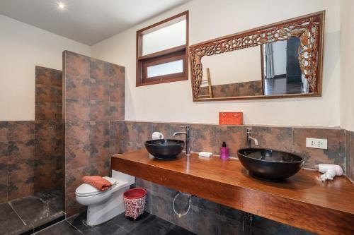 a bathroom with two sinks and a toilet at NB Villa Lilawadee in Chaweng Noi Beach