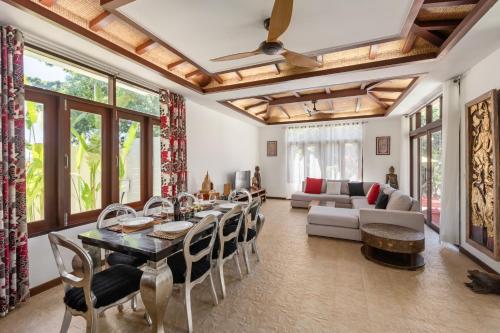 a living room with a table and chairs at NB Villa Lilawadee in Chaweng Noi Beach