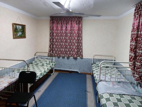 a room with two bunk beds and a window at Umid Hostel in Termiz