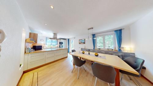 a kitchen with a table and chairs in a room at FERIENWOHNUNGEN TANJA - dein Wohlfühlhaus in Kappl in Kappl