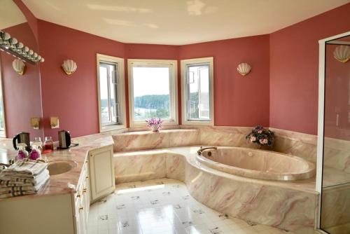 a large bathroom with two sinks and a tub at The Shearwater House - Panoramic Ocean View Suites in Nanaimo