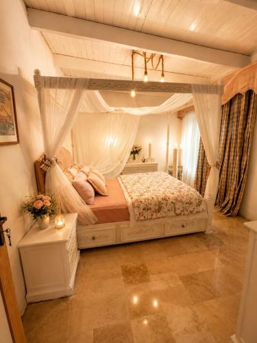 a bedroom with a canopy bed with pillows at chalet de paradis in Bizerte