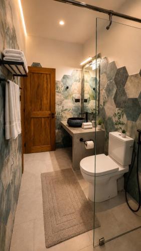 a bathroom with a toilet and a sink at Sea Esta in Le Morne