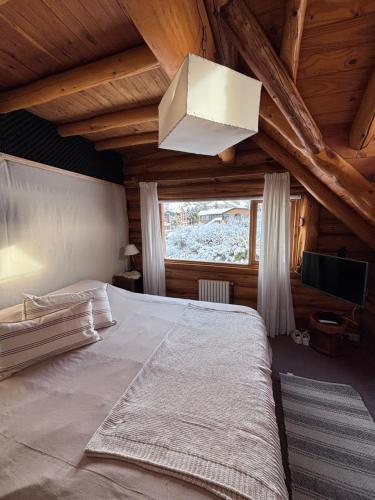 a bedroom with a large bed in a attic at Hosteria Sudbruck in San Carlos de Bariloche