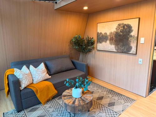 a living room with a couch and a table at La Estela NatureSuite in Mazamitla