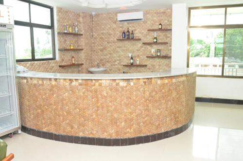 a bar in a kitchen with a brown counter top at Nefaland Hotel in Dar es Salaam