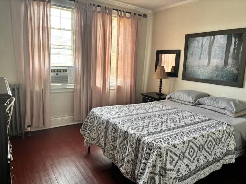 a bedroom with a large bed and a window at The Traveler Suite C1 in Hartford