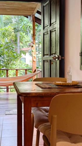 a wooden table in a room with a door at Zen Hideaway - Cute Modern Thai Home in Ko Phangan