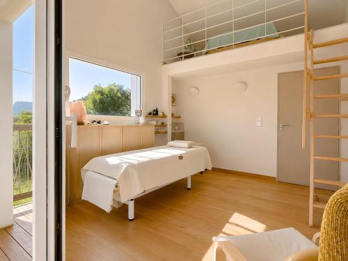 a bedroom with a bed and a balcony at Studio "Bulle de Sainte-Baume" in Plan dʼAups