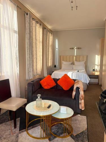 a living room with a couch and a bed at Mapungubwe apartment in Johannesburg