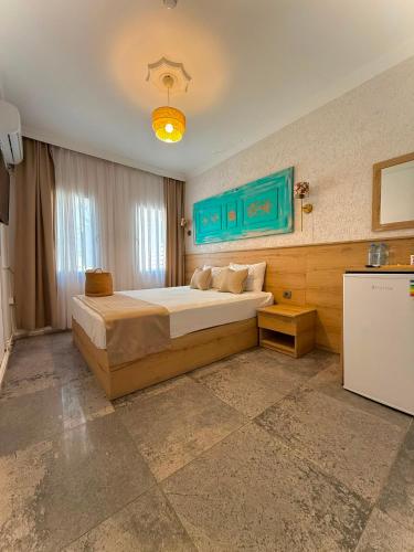 a bedroom with a large bed in a room at Bodrum Merkez Pansiyon in Bodrum City