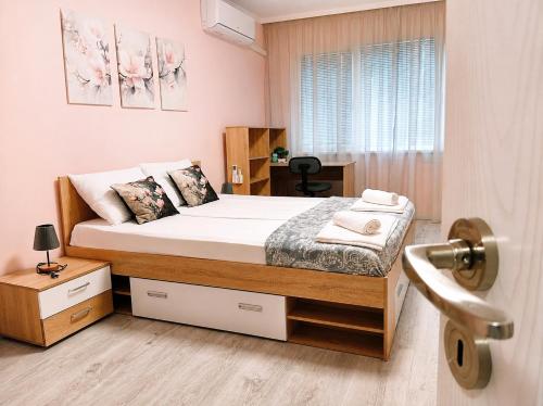 a bedroom with a bed and a window at P51 Central - Modern 2 Bedroom Apartment in Stara Zagora