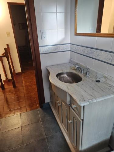 a bathroom with a sink and a mirror at Lo de Delia in City Bell
