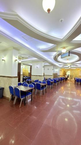 a banquet hall with blue chairs and tables in a room at Sama Al Bayt in Mecca