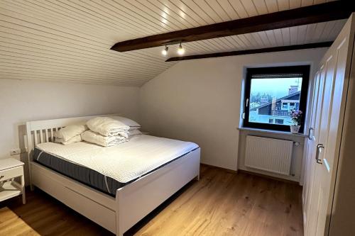 a small bedroom with a bed and a window at Apartment in the Upper Bavarian Alps in Bad Kohlgrub