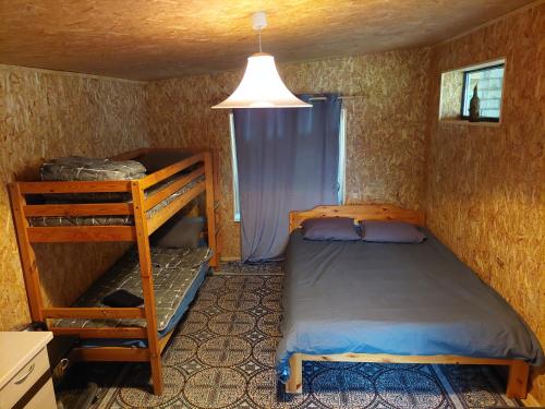 a small bedroom with a bunk bed and a ladder at Lind Guest House in Haapsalu