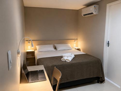 a bedroom with a bed with a towel on it at Smart Hotel Aeroporto by Bsb Inn in Brasília