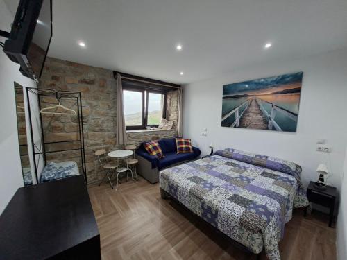a bedroom with a bed and a table in it at La Casona de Regolfo in Regolfo