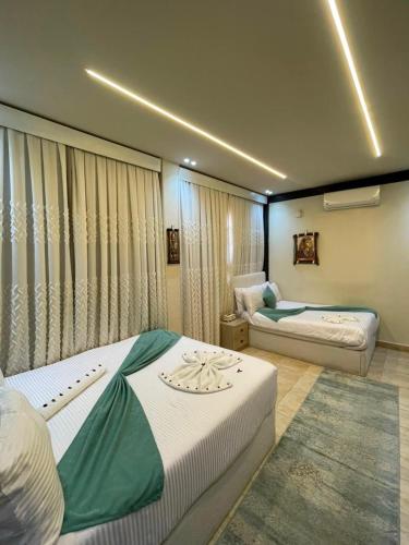 a hotel room with two beds in a room at Gaillon Scarab Pyramids View in Cairo