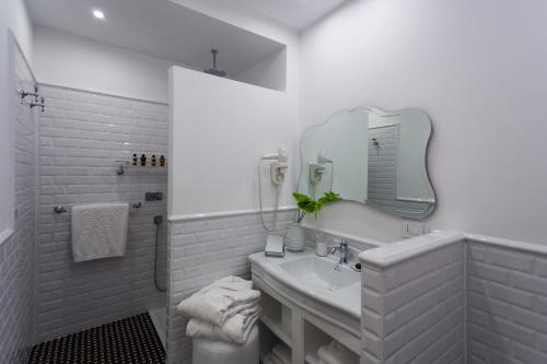 
a bathroom with a toilet, sink, and mirror at Hotel President in Viareggio
