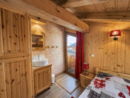 a bathroom with a bed and a sink in a room at Le Tyrol in La Plagne Tarentaise