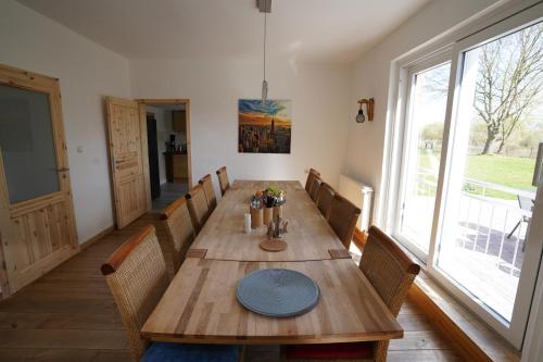 a dining room with a wooden table and chairs at Ferienhaus Weserblick in Rinteln