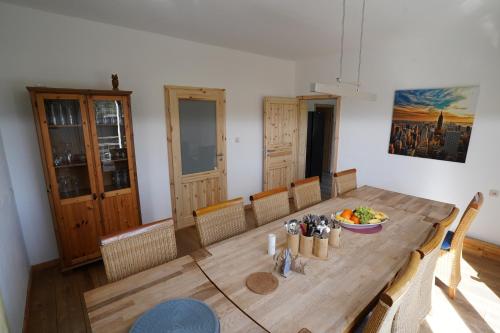 a dining room with a wooden table with a bowl of food at Ferienhaus Weserblick in Rinteln