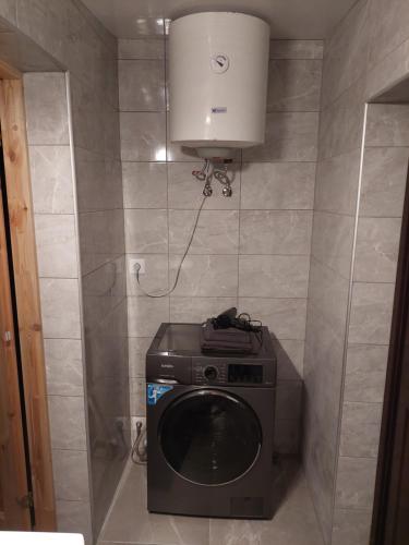 a washer and dryer in a small bathroom at Lind Guest House in Haapsalu