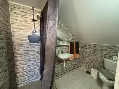 a bathroom with a sink and a toilet at BnBBonaire near the ocean in Kralendijk