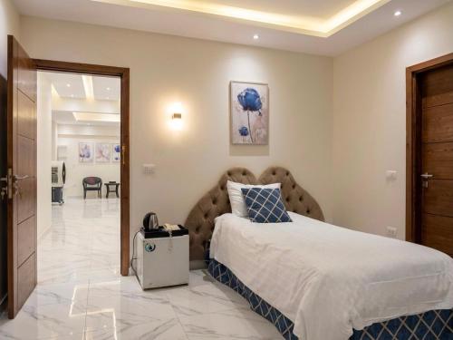 a bedroom with a large bed and a hallway at Dera October city in 6th Of October
